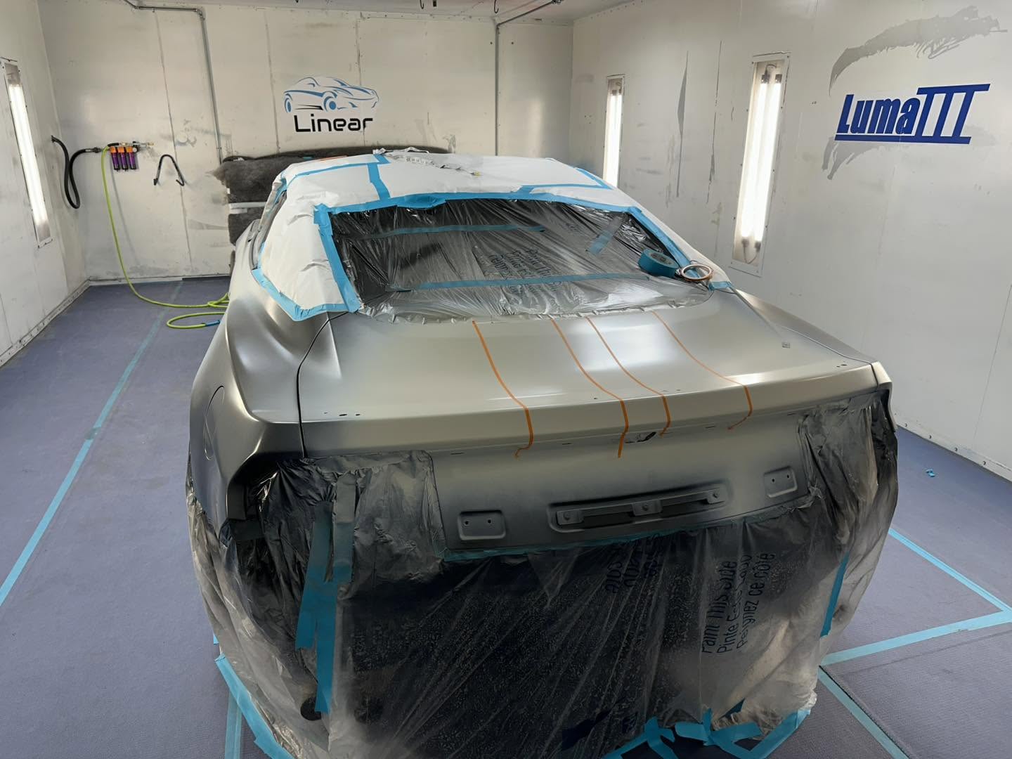 Rear view of the Phantom Blue Mustang stripe layout in the Linear paint booth