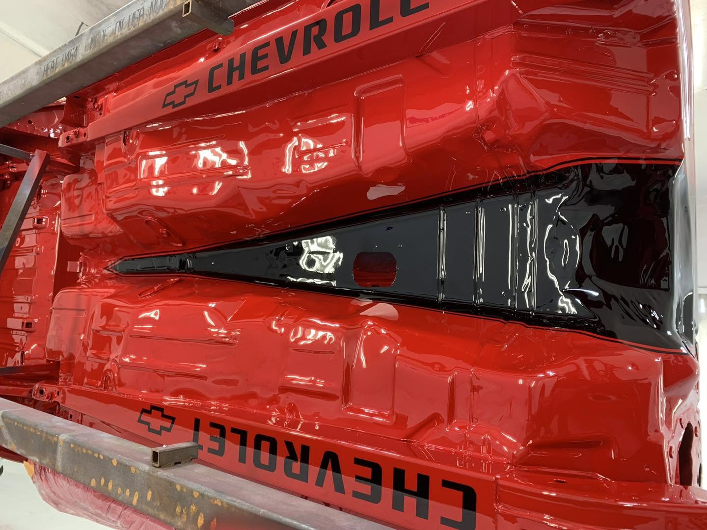 GM Solar Red and black-painted underside of the 1969 Chevrolet Camaro on a rotisserie