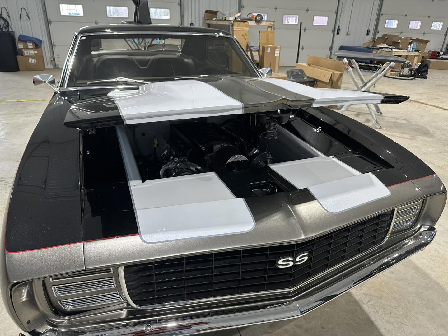 Front three-quarter view of the Grizzly Gray Camaro with the hood open in the shop