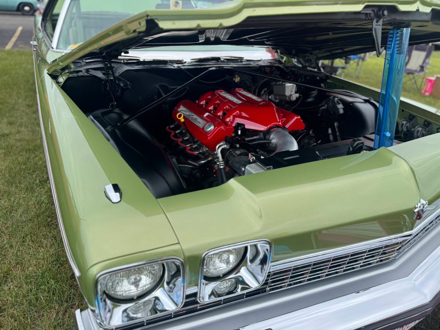 Engine bay of the Leaf Green Buick Electra with a red-finished LS engine