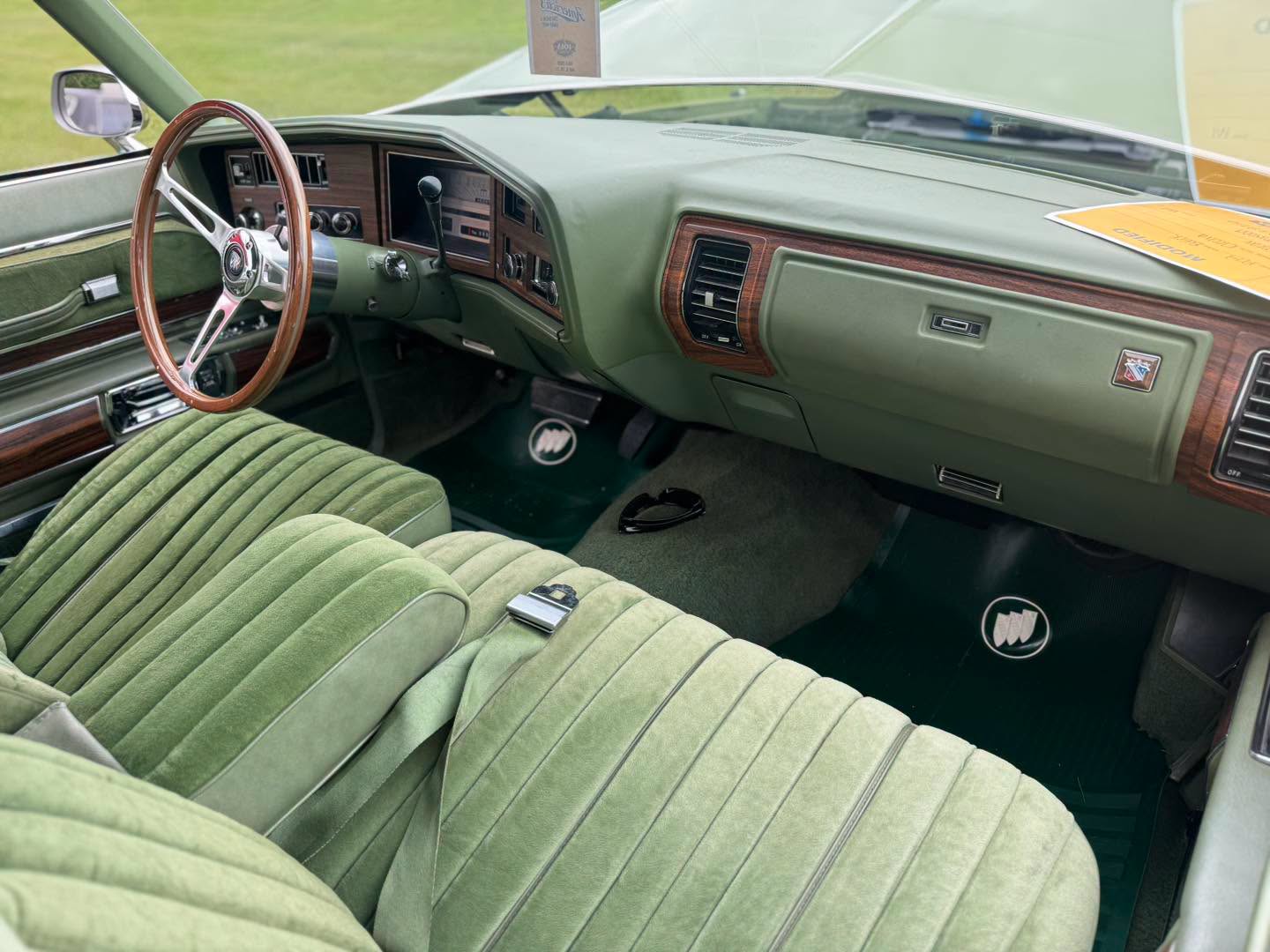 Green cloth interior and woodgrain dash of the Buick Electra