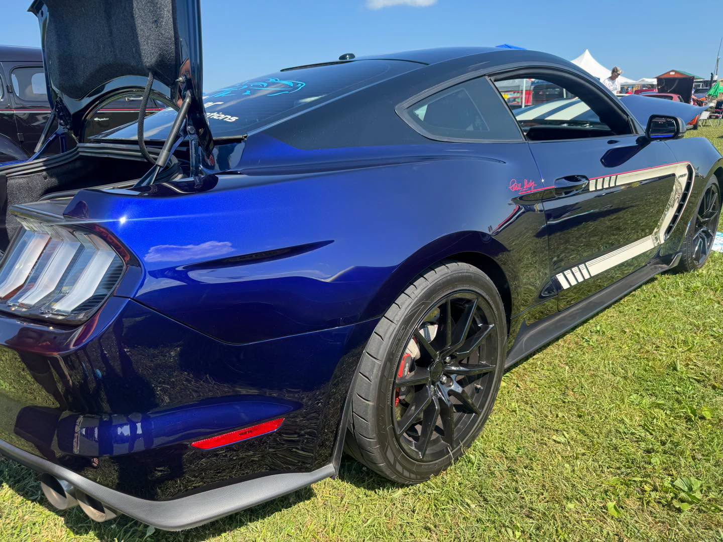 Rear three-quarter view of the finished Phantom Blue GT350 in sunlight